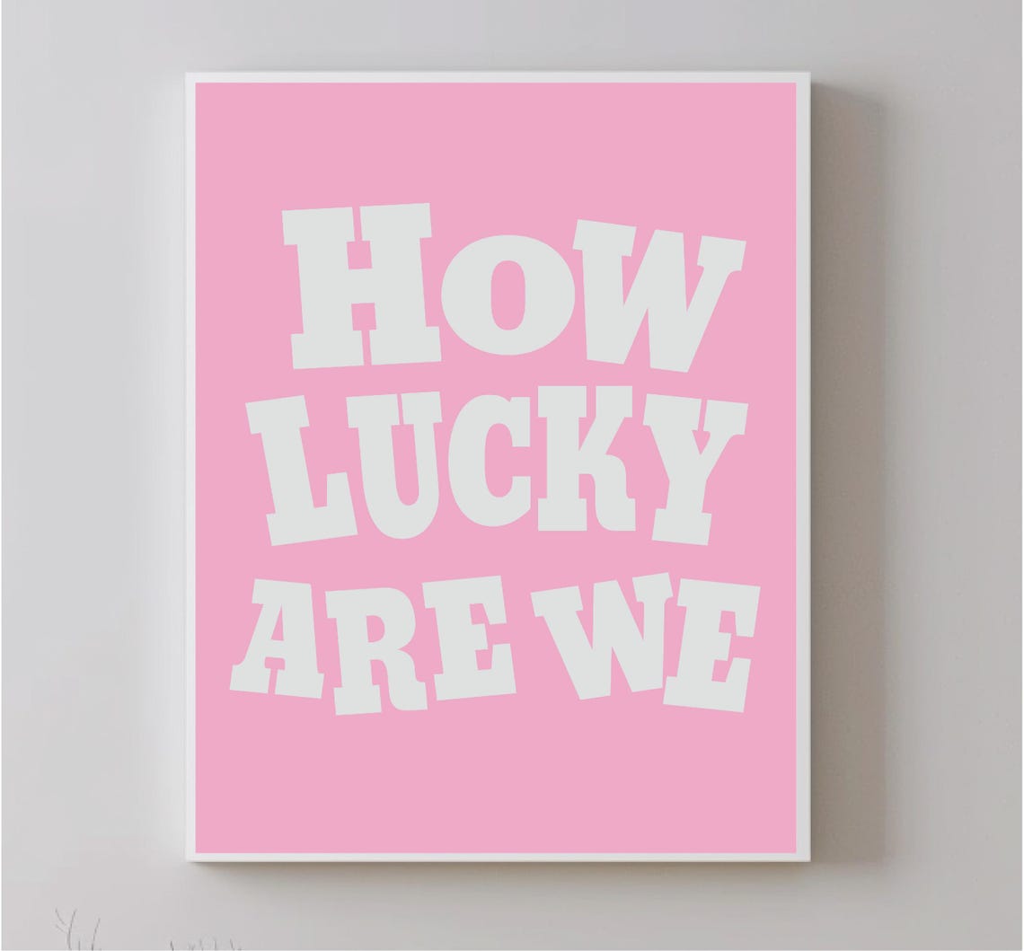 How Lucky Are We White Bold Typography Pink Background Wall Art