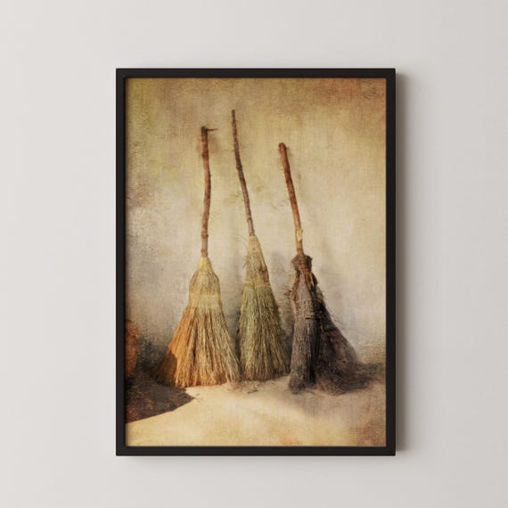 Three Vintage Straw Brooms Against a Rustic Farmhouse Wall Poster