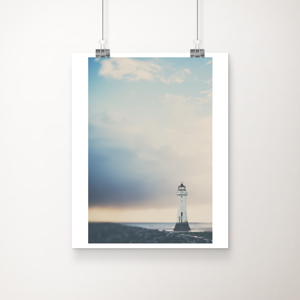White Lighthouse at Dusk on Rocky Shore Moody Sky Photo Print