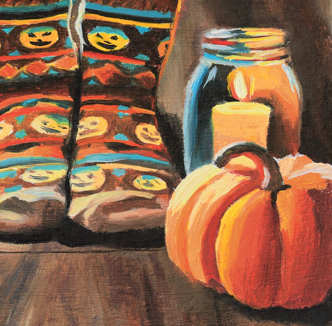 Cozy Halloween Scene with Pumpkin Socks, Pumpkins and Candlelight Poster - Image 2