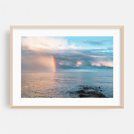 Vivid Rainbow Over Calm Ocean With Rocky Shore At Sunset Poster