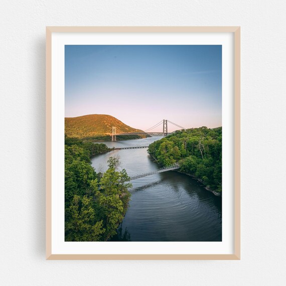 Suspension Bridge Crossing A Wooded River At Soft Twilight Poster