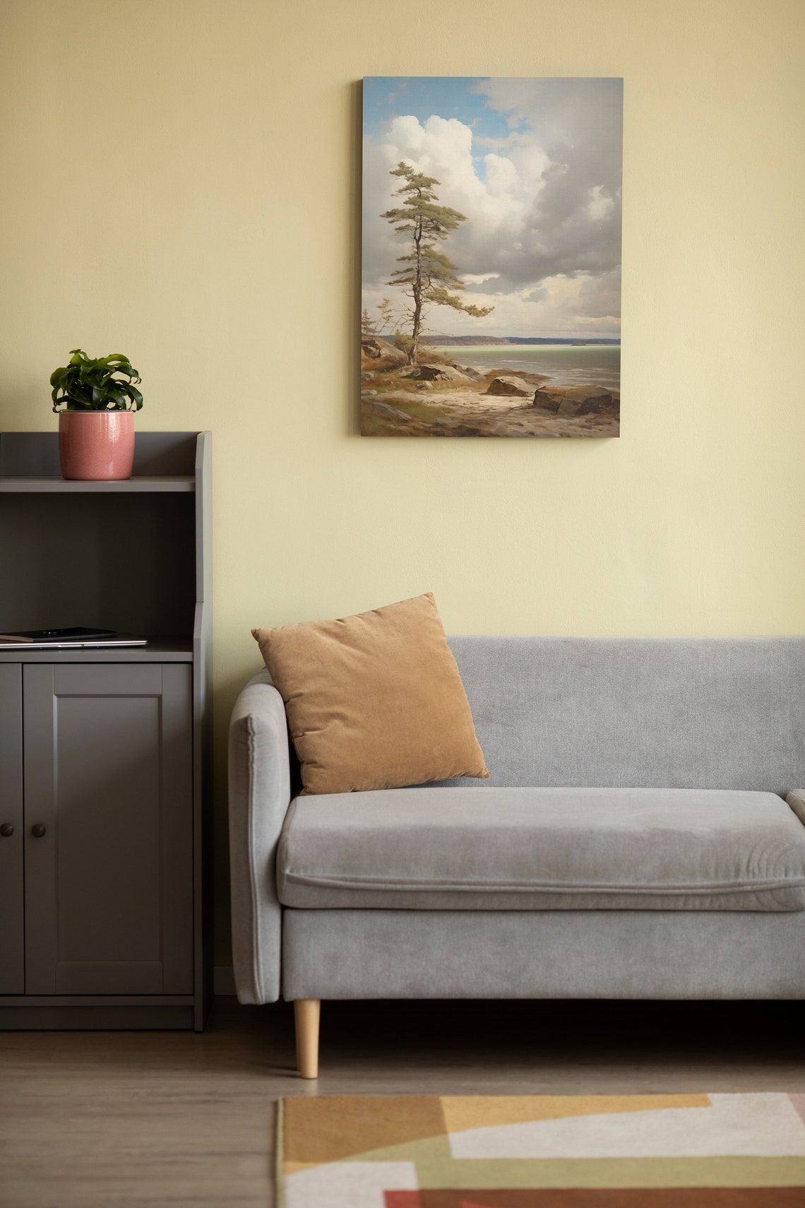 Lone Pine Tree on Rocky Shore Beneath Dramatic Cloudy Sky Poster - Image 2