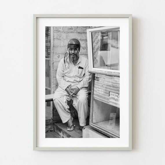 Man With Helmet By Juice Shop Black And White Street Photo Poster