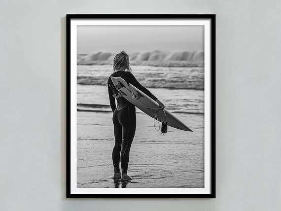 Woman in Wetsuit Holding Surfboard Watching Waves Beach Poster
