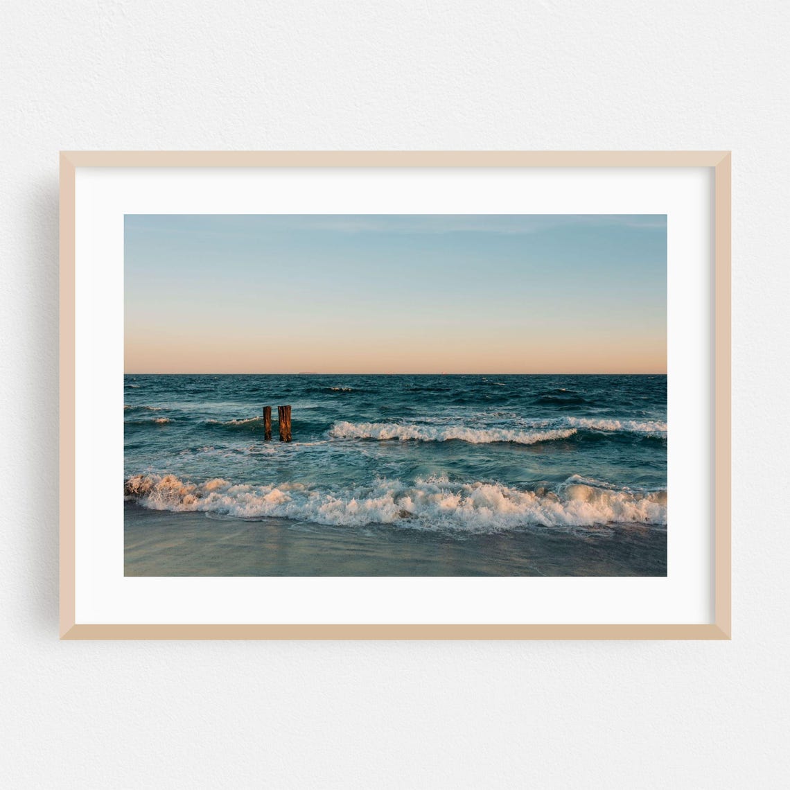 Ocean Sunset With Weathered Wooden Pilings And Rolling Surf Poster