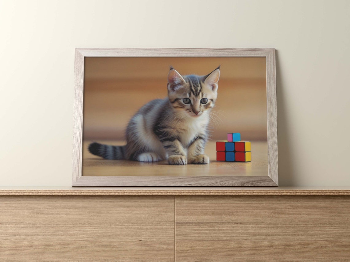 Curious Gray Tabby Kitten Sitting Beside Tiny Rubik Cube Toy Poster - Image 2