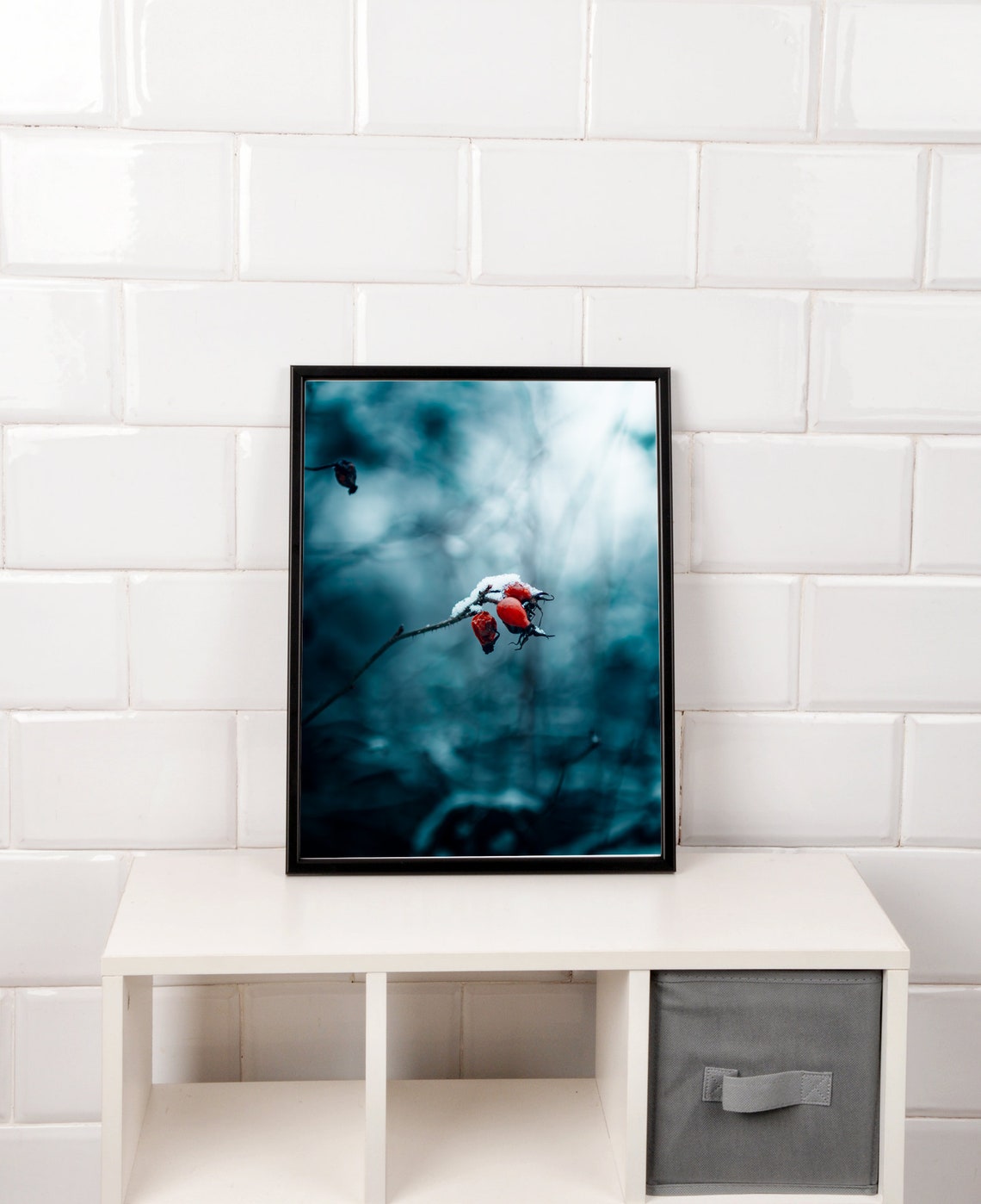 Snow-Dusted Red Rose Hips Glowing Against a Cold Blue Winter Poster