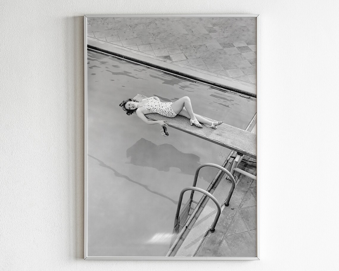 Vintage Black and White Photo of a Woman Lounging on a Diving Board Poster