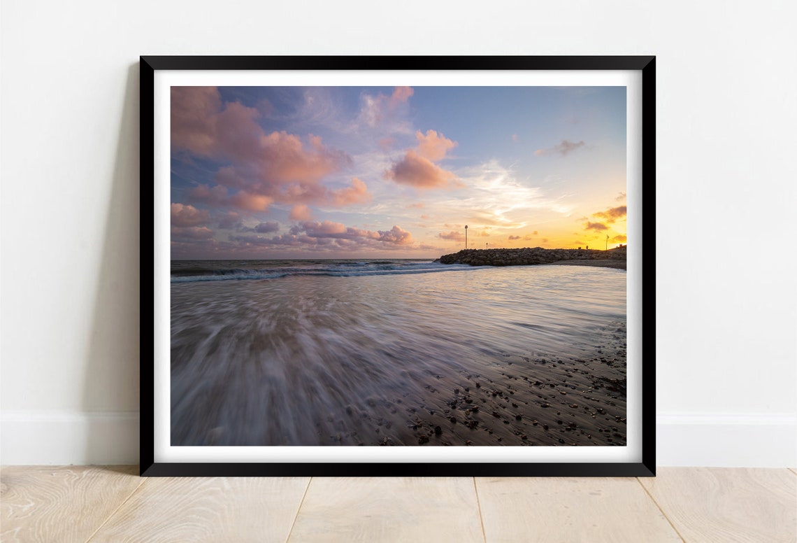 Golden Sunset Over Ocean Beach Waves with Rocky Breakwater Poster
