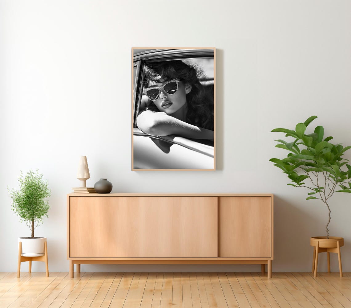 Black and White Close-Up Woman in Sunglasses Leaning from Car Poster - Image 2