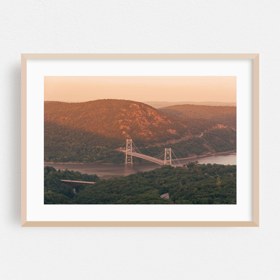 Suspension Bridge Spanning A Wide River Canyon At Sunset Poster