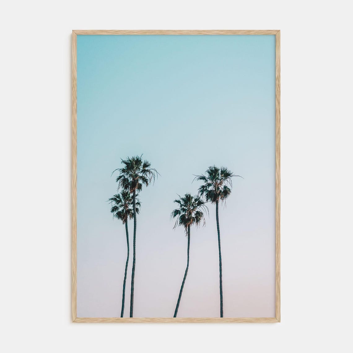 Tall Palm Tree Silhouettes Against a Soft Pastel Dawn Sky Poster