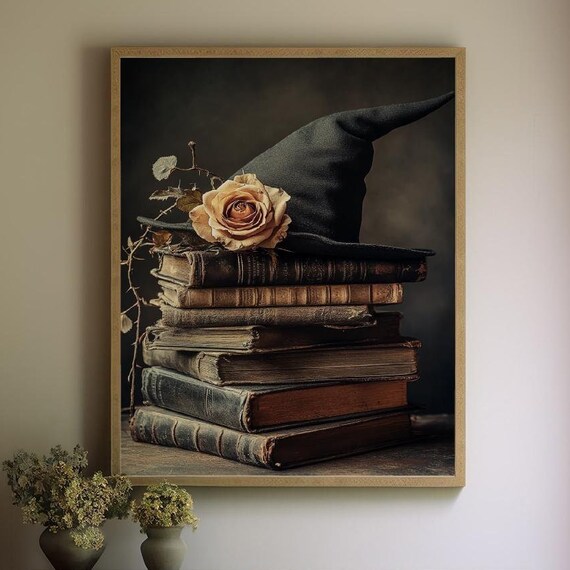 Black Witch Hat and Dried Rose Resting on a Stack of Old Books Poster