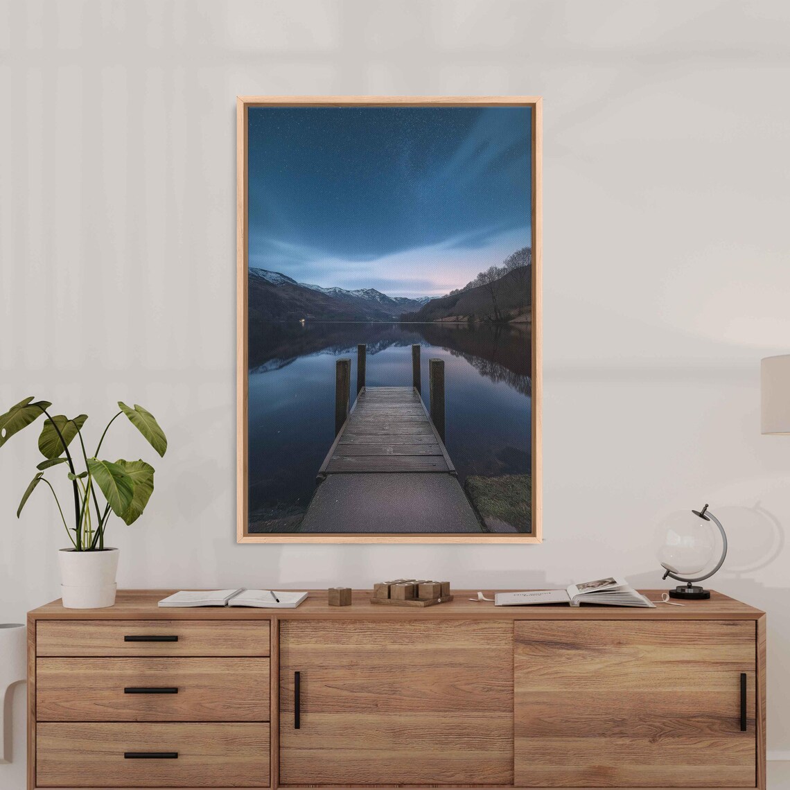 Wooden Dock Stretching Into A Calm Mountain Lake At Dusk Poster