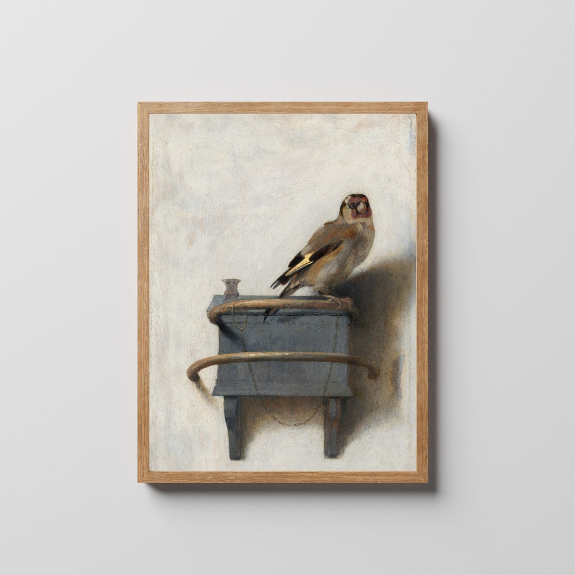 Chained Goldfinch Perched Atop a Small Wall-Mounted Feeder Poster - Image 2