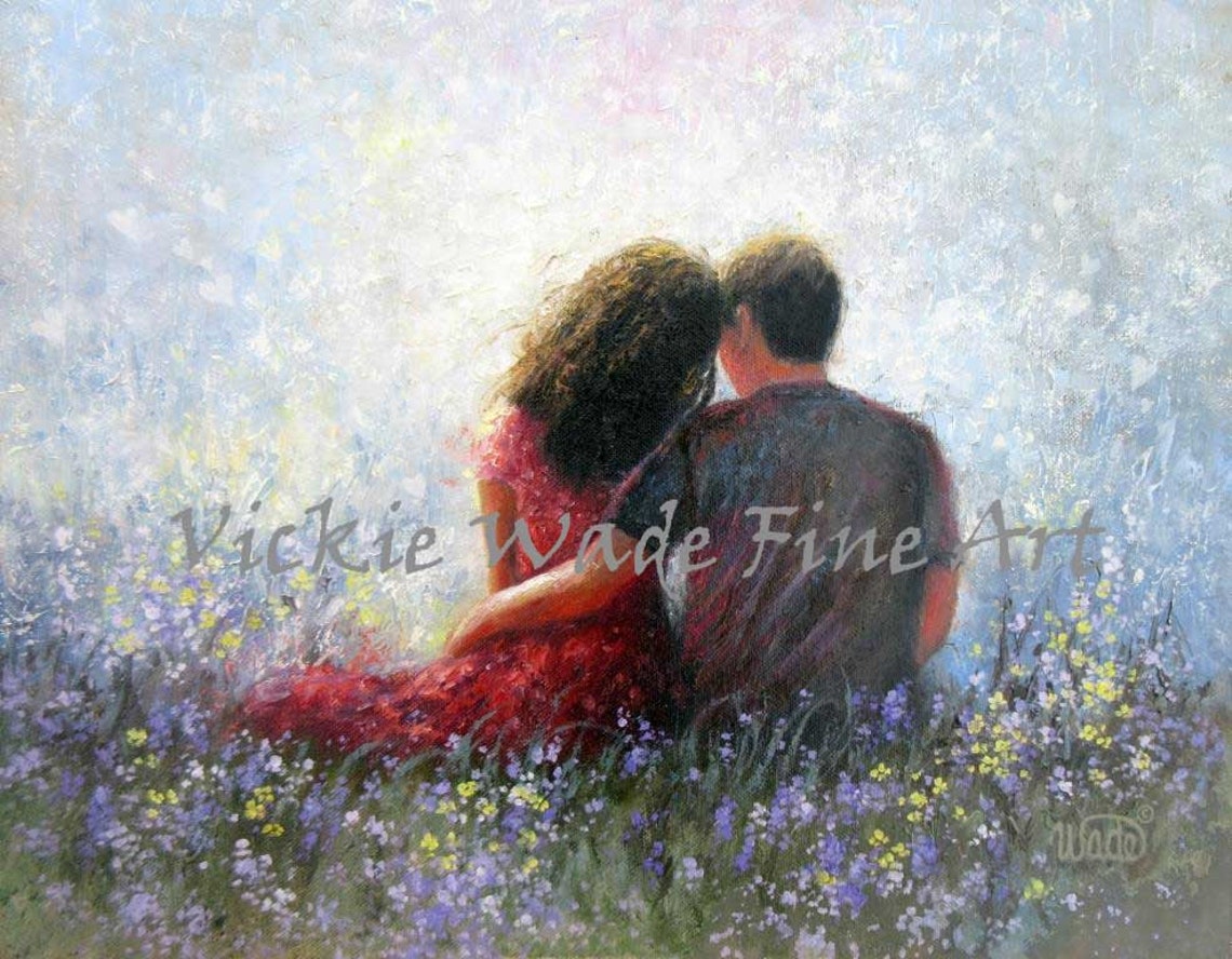 Loving Couple Sitting Close in a Wildflower Meadow at Sunset Poster