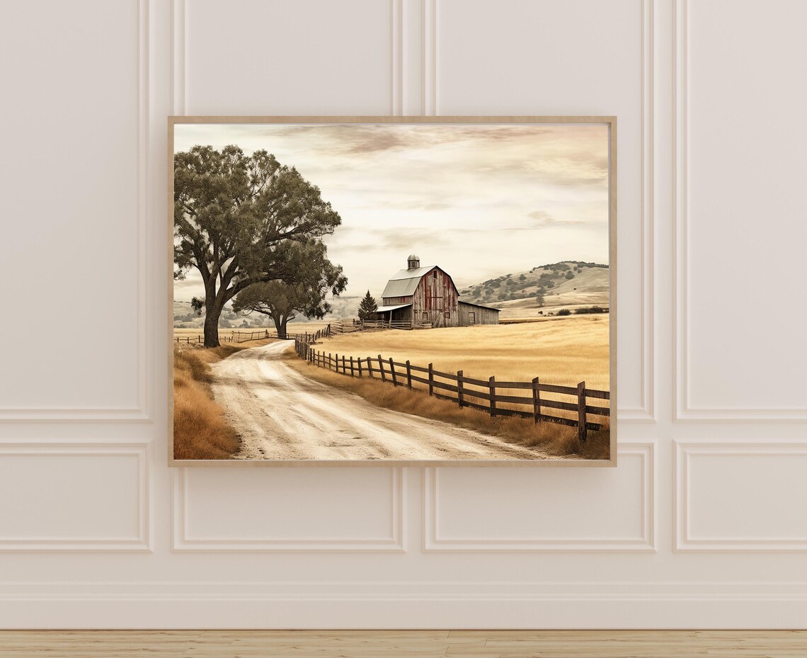 Rustic Red Barn Beside a Winding Dirt Road in a Golden Field Poster