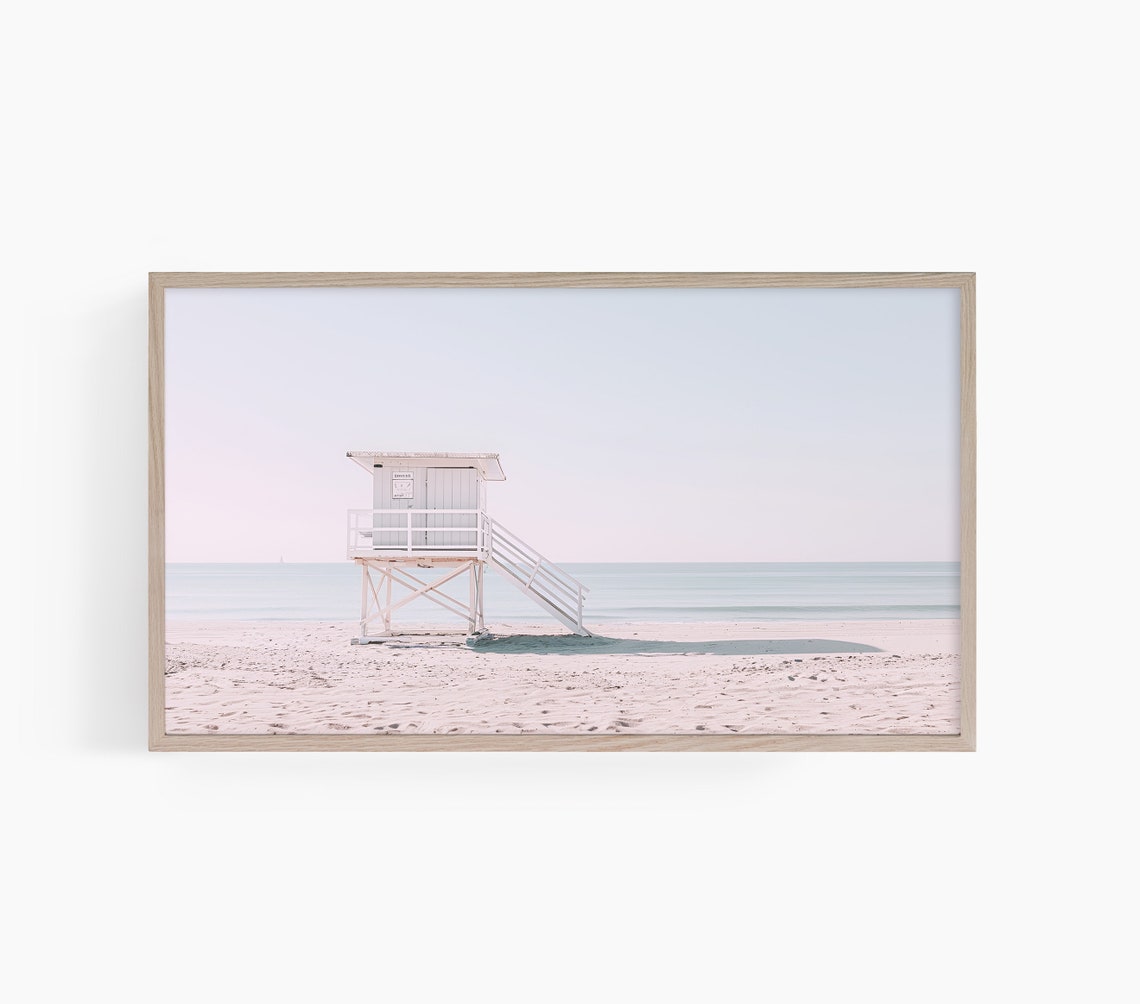 White Lifeguard Tower Standing on an Empty Pastel Sandy Beach Poster