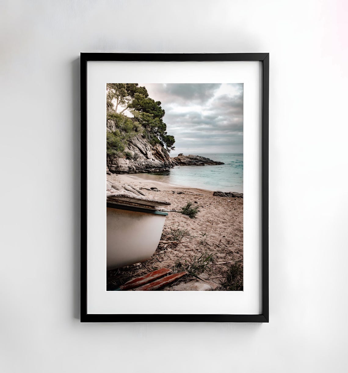 Weathered Wooden Boat Resting on a Quiet Spanish Cove Beach Poster
