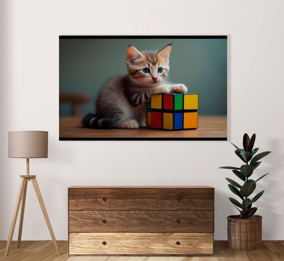 Blue-Eyed Kitten Playing With a Colorful Rubik Cube Toy Poster