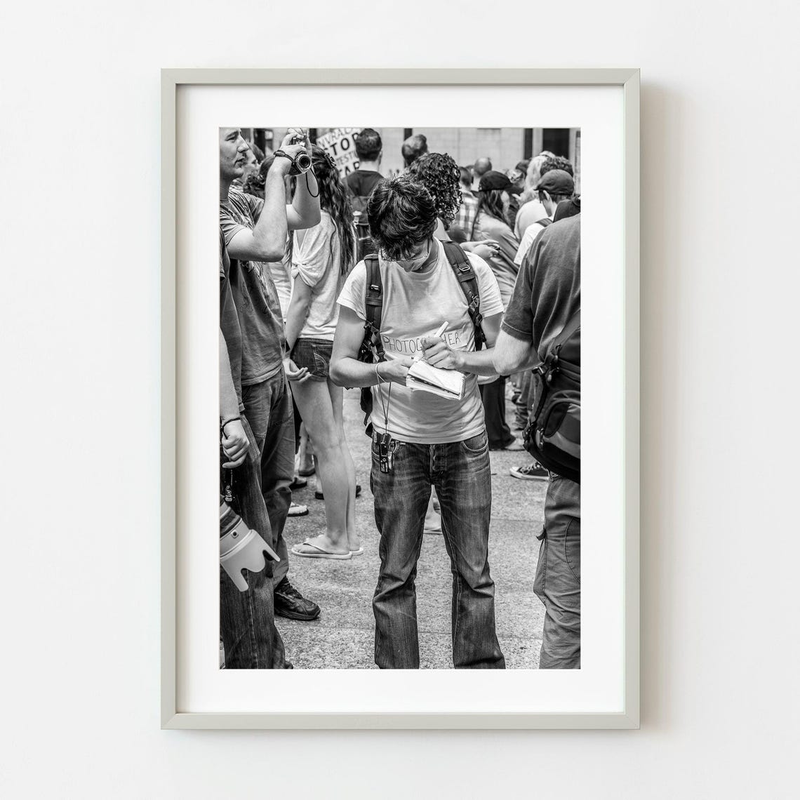Young Photographer Taking Notes Crowd Black And White Photo Poster