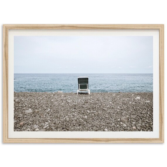 Minimalist Pebble Beach Chair Facing Calm Sea Photo Art Print