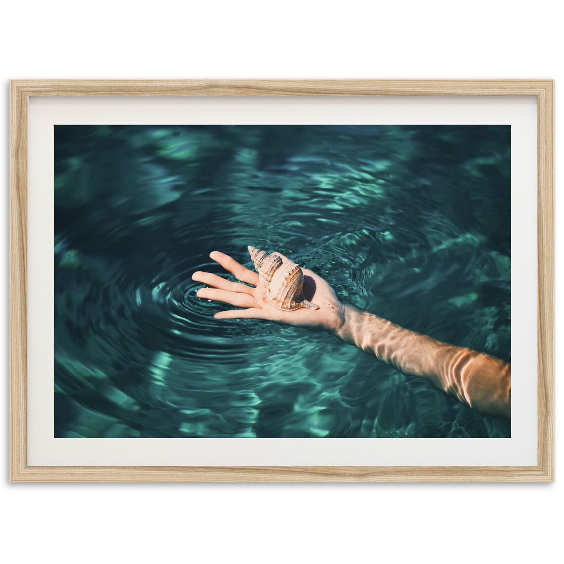 Hand Holding Seashell Over Teal Ocean Water Photography Poster