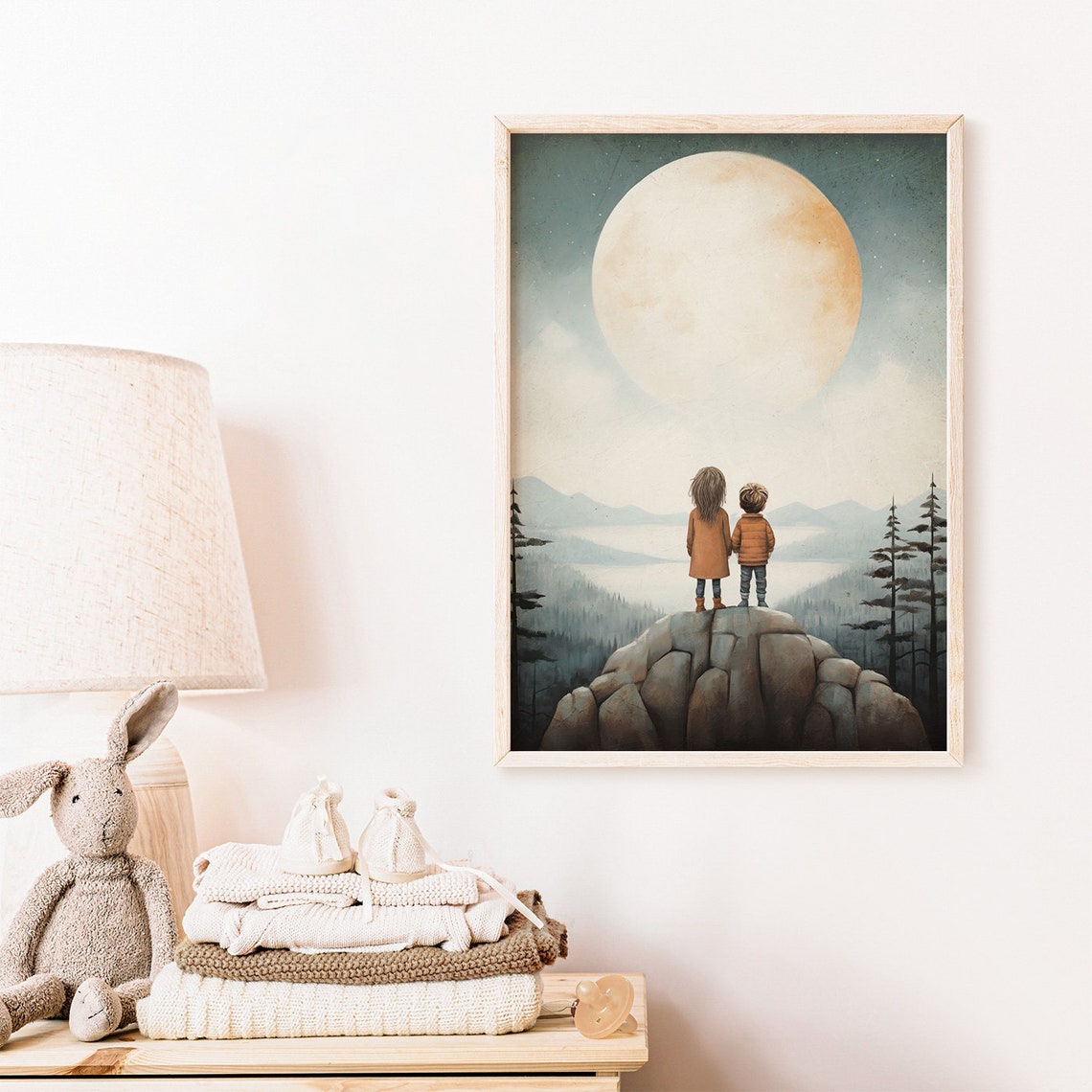 Two Young Siblings Standing On Rocky Peak Under Giant Moon Poster - Image 2