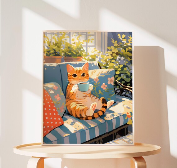Orange Tabby Kitten Sipping Coffee on a Sunlit Blue Sofa Poster
