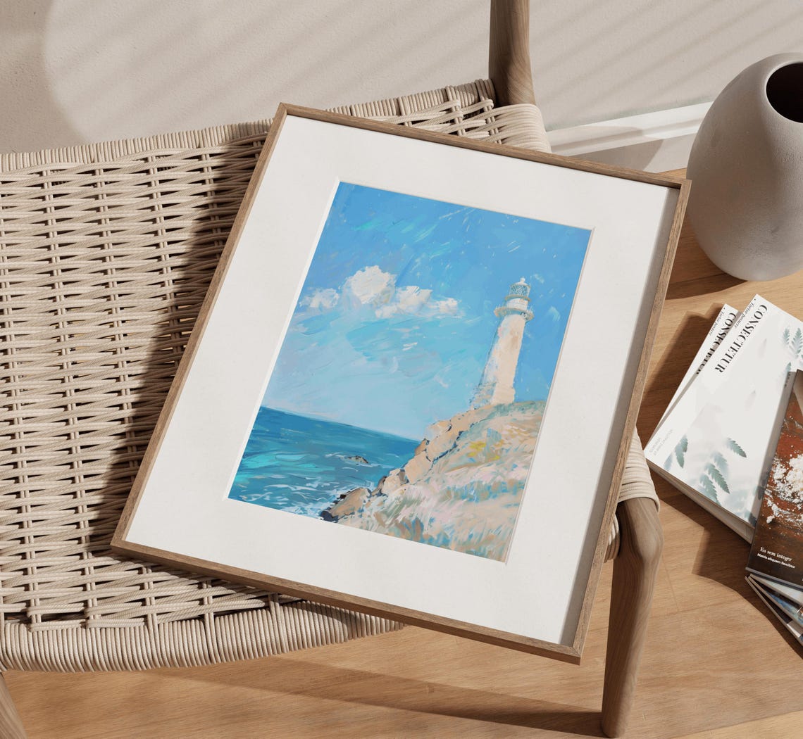White Lighthouse Standing On Rocky Cliff Above Blue Ocean Poster