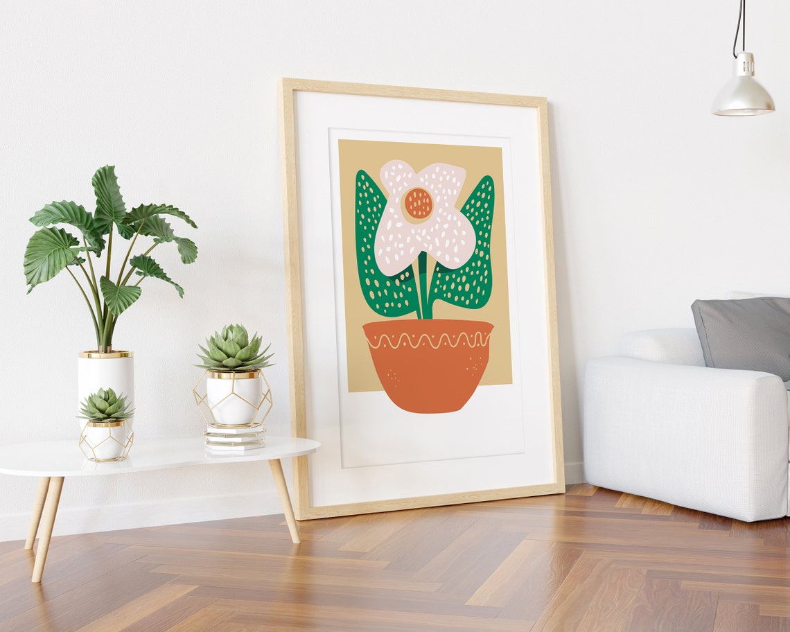 White Dotted Flower in Orange Pot Green Leaves Graphic Poster - Image 3