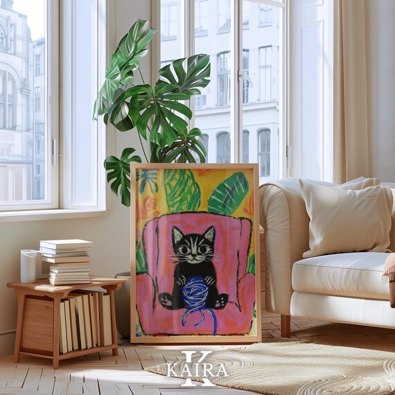 Black Kitten Playing With a Yarn Ball on a Pink Chair Poster