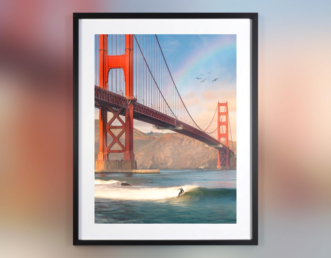 Golden Gate Bridge Surfer Riding Wave Under Rainbow Sky Poster