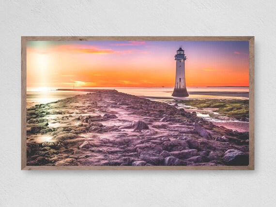 Lighthouse Sunset Rocky Causeway Vibrant Orange Sky Coastal Travel Poster