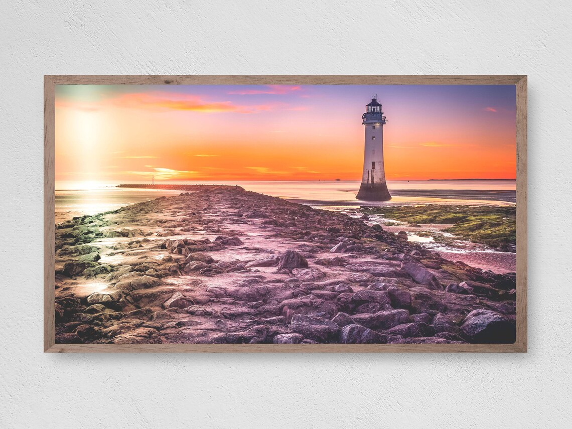 Lighthouse Sunset Rocky Causeway Vibrant Orange Sky Coastal Travel Poster