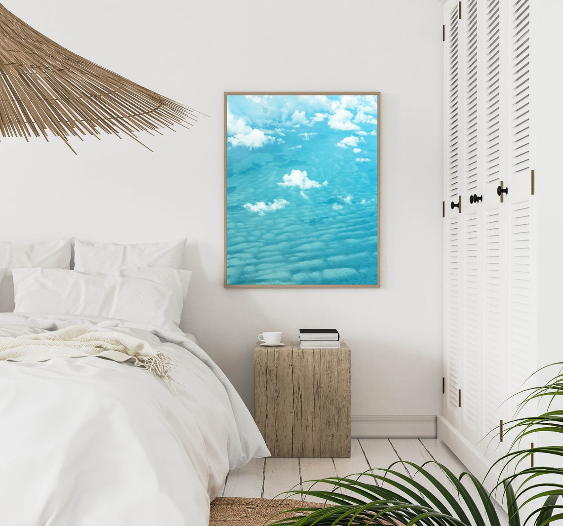 White Clouds Drifting Over a Bright Turquoise Ocean Surface Poster - Image 3