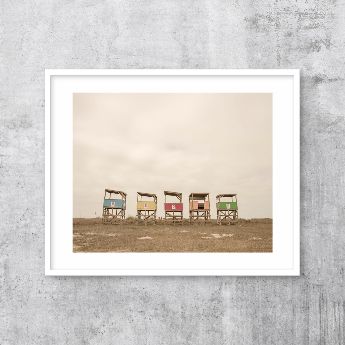 Row of Colorful Lifeguard Towers on a Beach Under Grey Sky Poster - Image 3