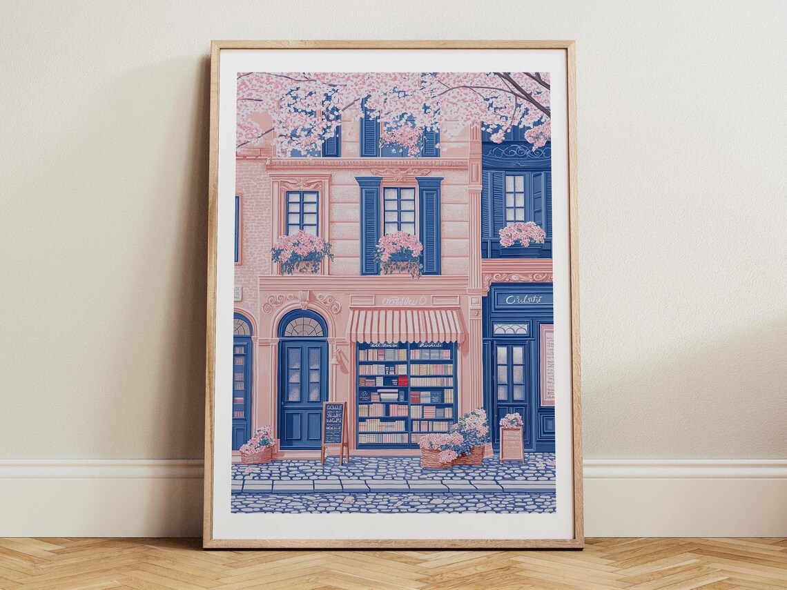 Pink Bookshop Facade With Striped Awning On Cobblestone Street Poster
