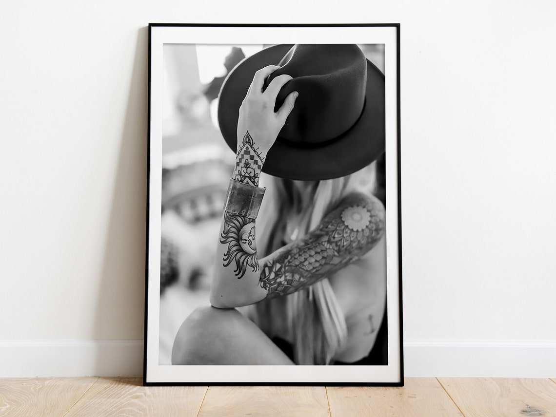 Tattooed Woman Holding Cowboy Hat Over Face Black and White Poster - Image 3
