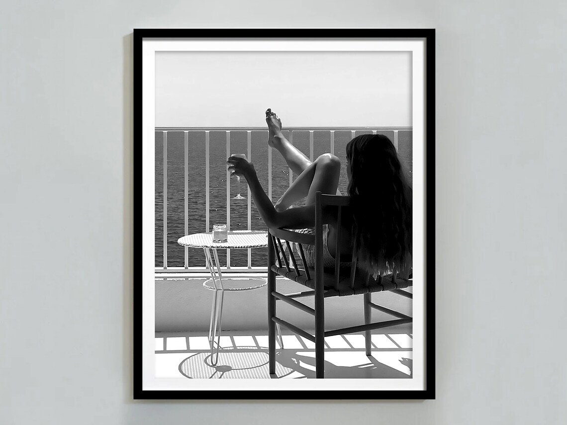 Woman Relaxing On Balcony With Wine Glass Overlooking Ocean Views Poster