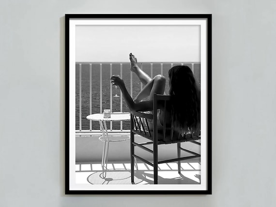 Woman Relaxing On Balcony With Wine Glass Overlooking Ocean Views Poster