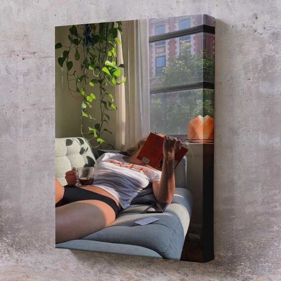 Woman Reading A Book On Cozy Couch With Tea Sunlit Window Wall Art