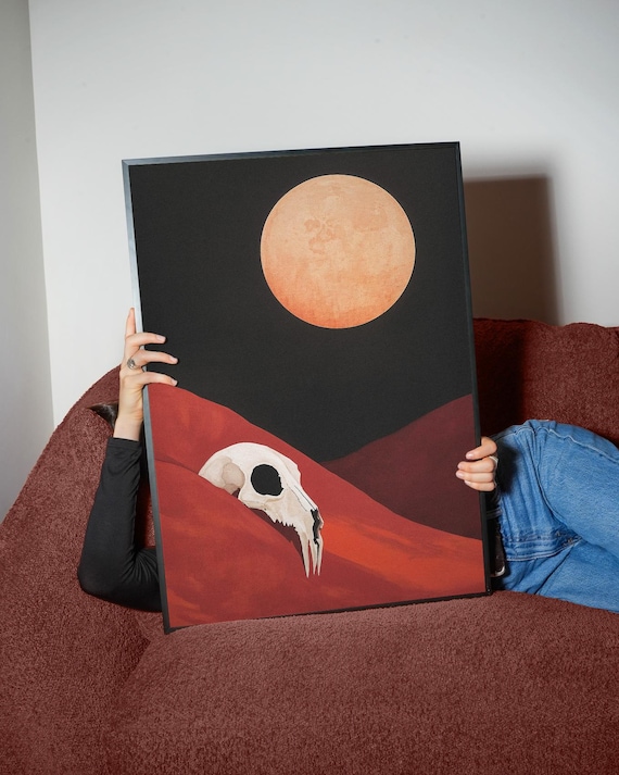 Animal Skull Resting in Red Desert Dunes Under a Huge Orange Moon Poster