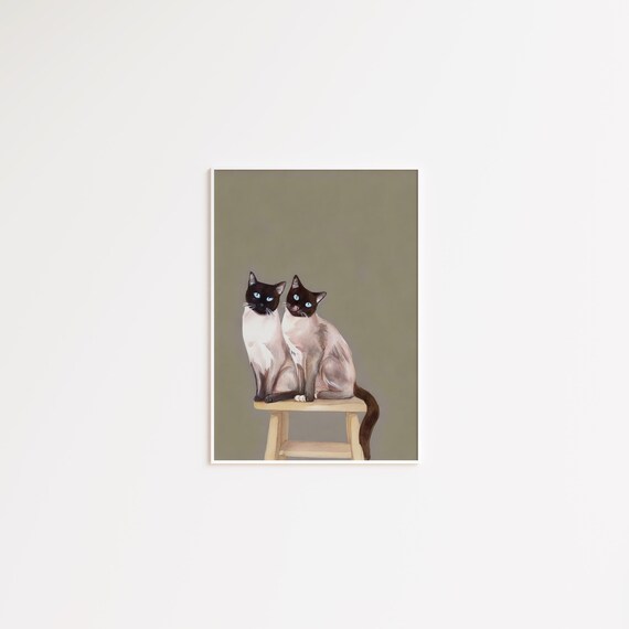 Two Siamese Cats Sitting Together on a Wooden Stool Poster Art