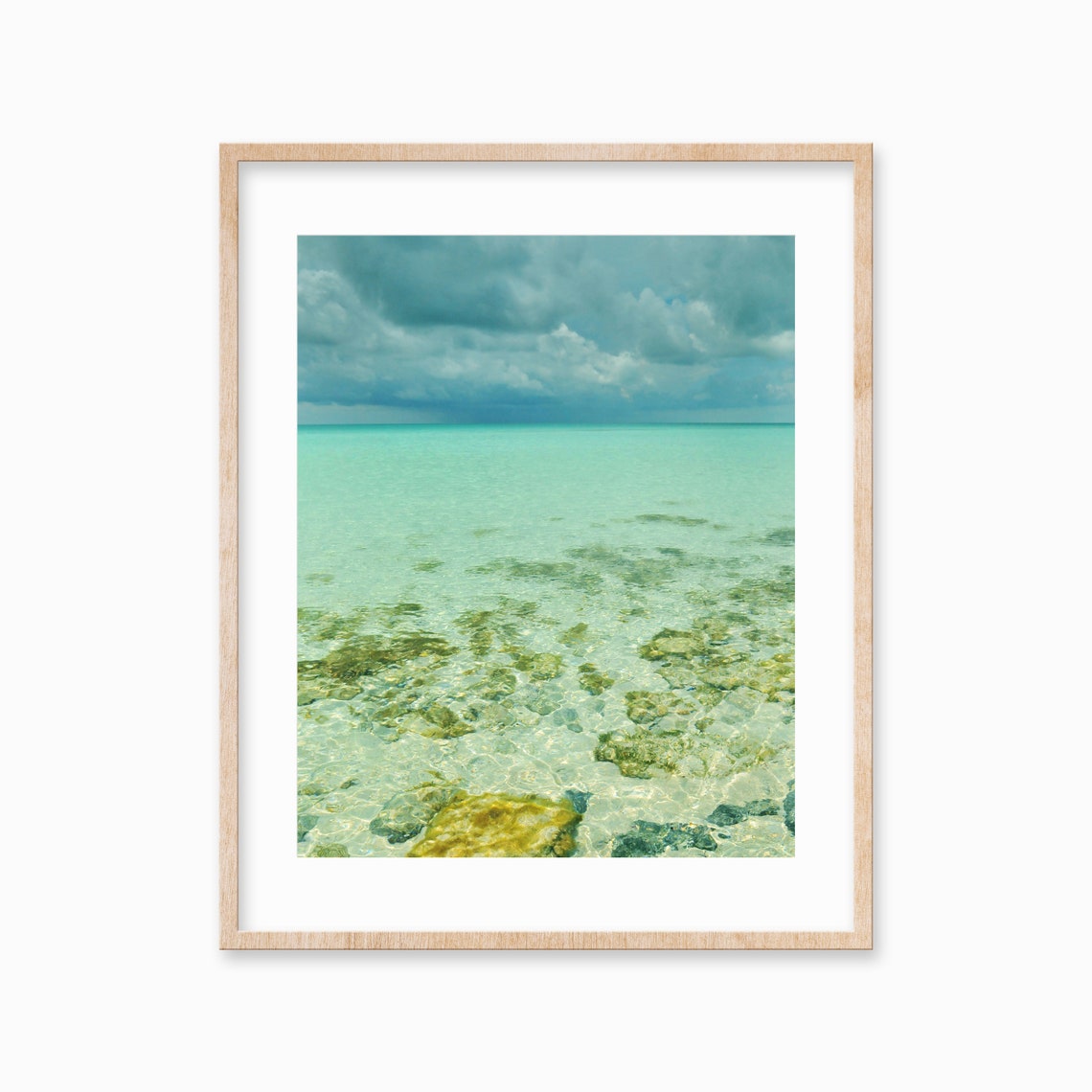 Crystal Clear Shallow Sea with Rocks Under Storm Clouds Poster