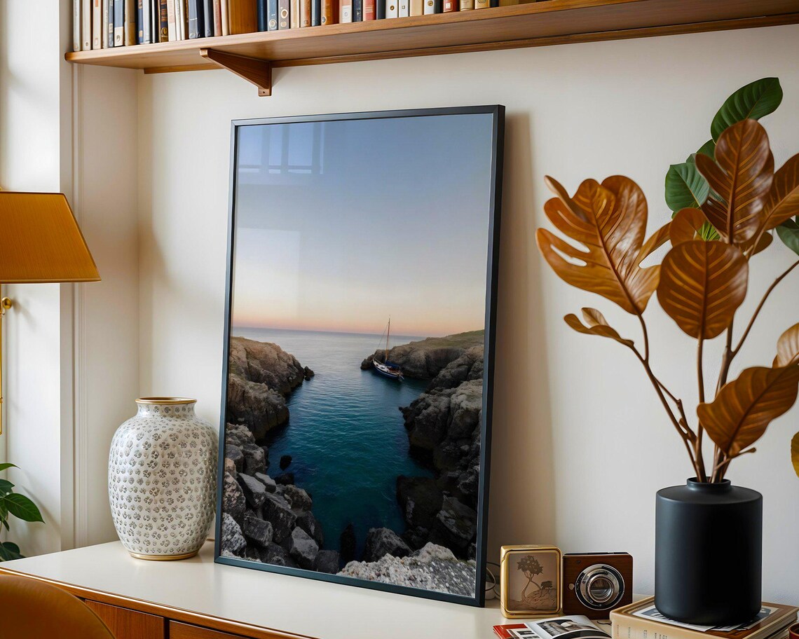 Lone Sailboat Anchored in a Rocky Coastal Cove at Dusk Poster - Image 3