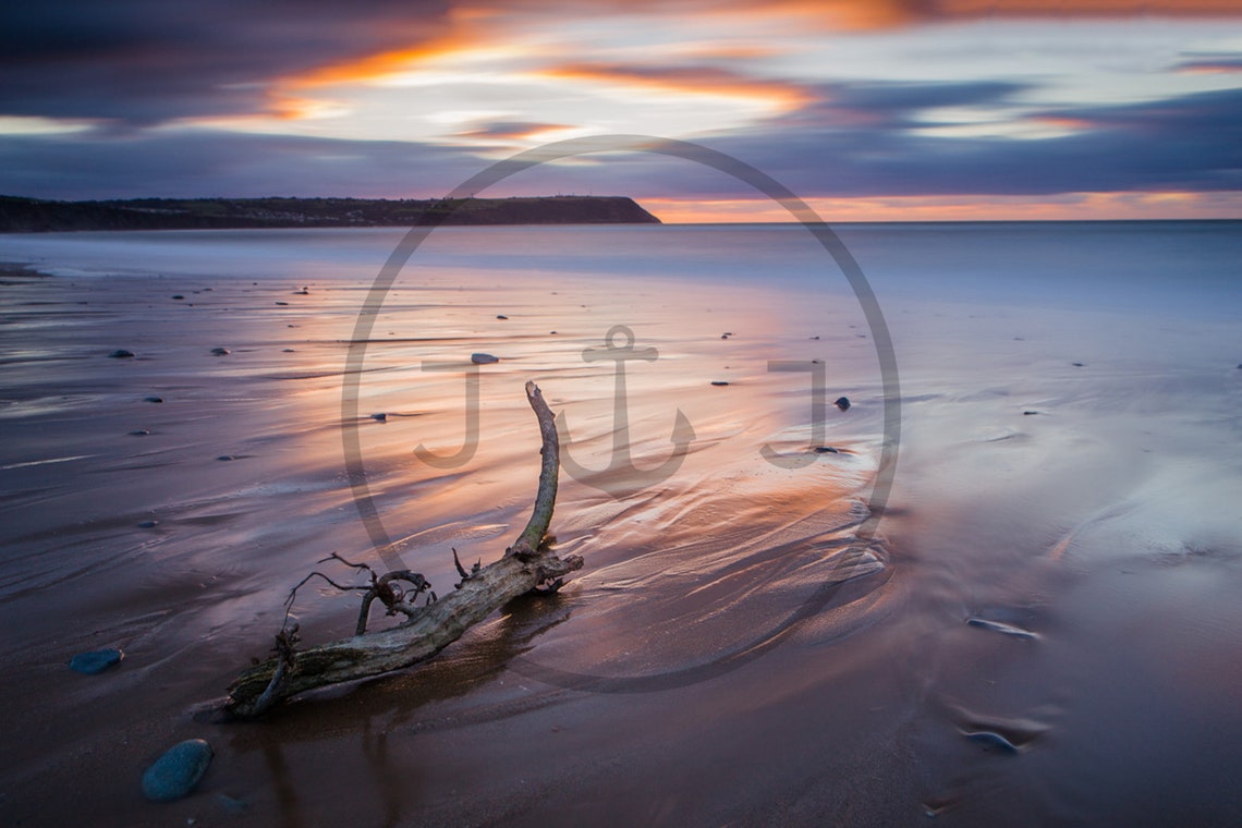 Driftwood Resting on Wet Sand Under a Soft Pink Twilight Sky Poster - Image 3