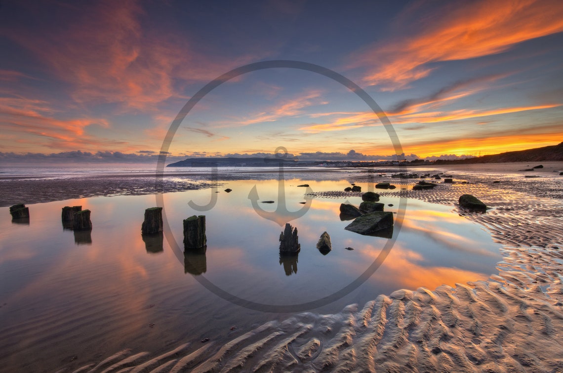 Old Wooden Groynes on Wet Sand at Sunset with Reflections Poster - Image 3