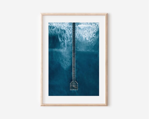 Aerial View Of Wooden Pier Stretching Into Deep Blue Ocean Poster